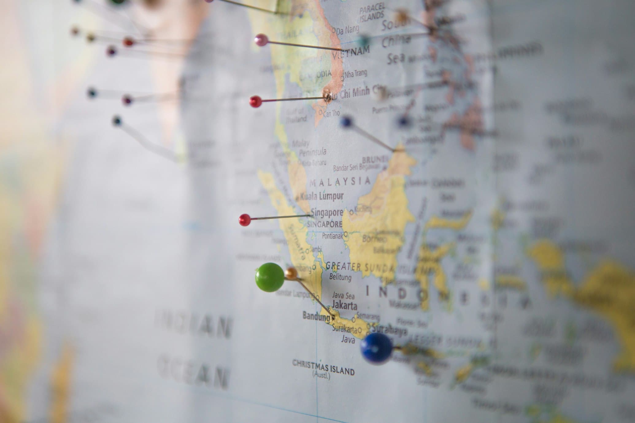 A paper map with colored pins marking planned destinations.